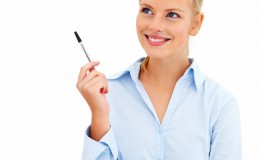 Cut out of happy young businesswoman  pointing pen