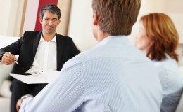 Successful bank executive in a discussion with a young couple