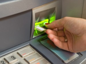 Inserting plastic card visa into ATM